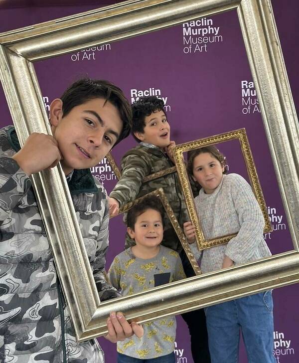 Image of kids holding frames and looking thorugh them at viewer.