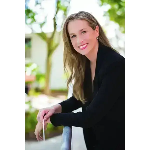 Women smiling with black blazer